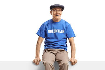 Elderly man volunteer sitting on blank panel