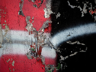 Abstract graffiti in black and red on a white wall