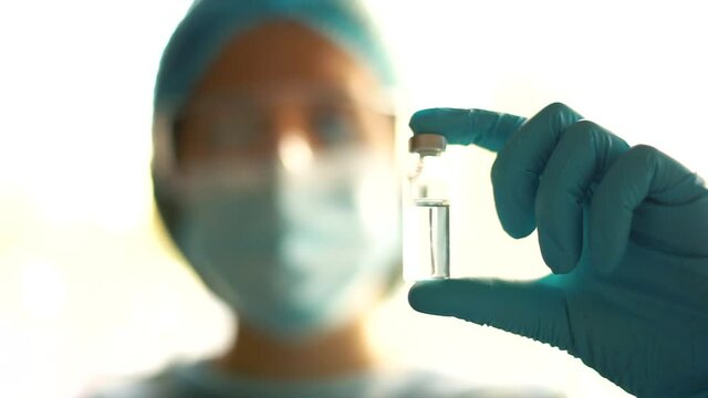 Medical doctor or laborant holding tube with nCoV Coronavirus vaccine for 2019-nCoV virus.