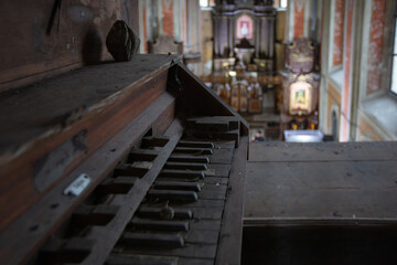 Fototapeta na wymiar Roman Catholic Church of Nativity of the Blessed Virgin Mary in Komarno, Lviv region, Ukraine. Ancient organ console