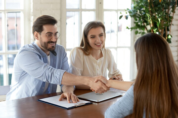 Smiling male employer shake hand of female job candidate or applicant after successful interview in office. Happy man recruiter handshake get acquainted or close deal with client. Employment concept.