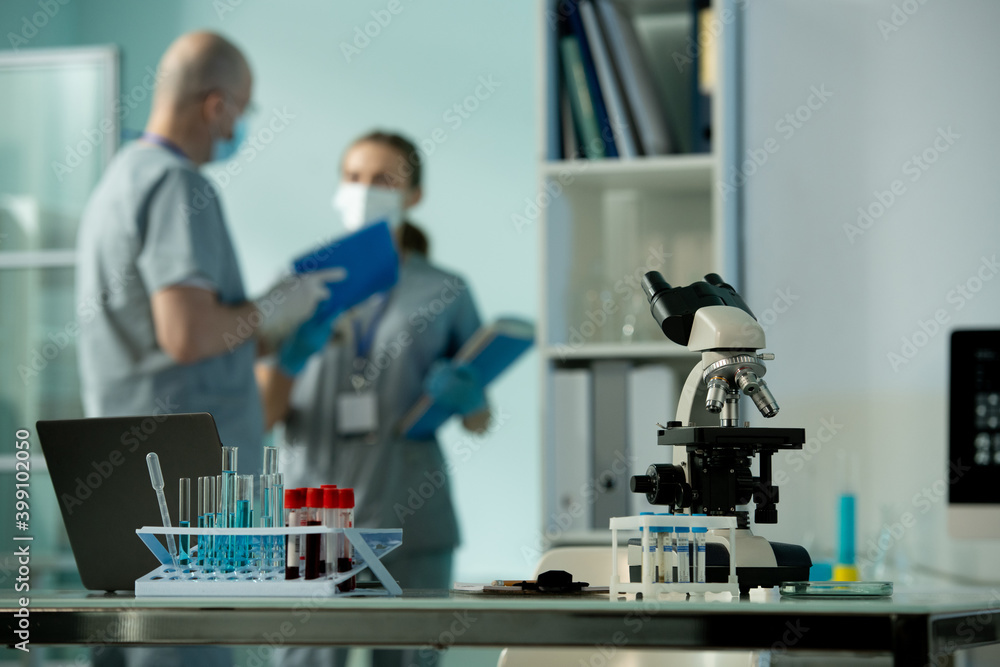 Poster Workplace of scientist or laboratory worker with group of flasks and microscope