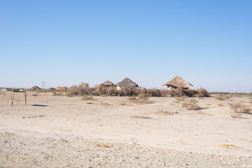 Mud straw and wooden hut with thatched roof in the bush. Local village in the rural Caprivi Strip, the most populated region in Namibia, Africa.