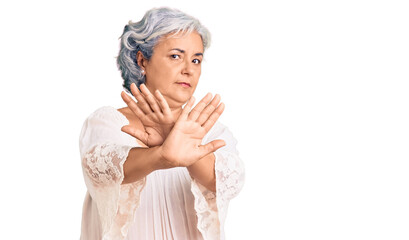 Senior woman with gray hair wearing bohemian style rejection expression crossing arms doing negative sign, angry face