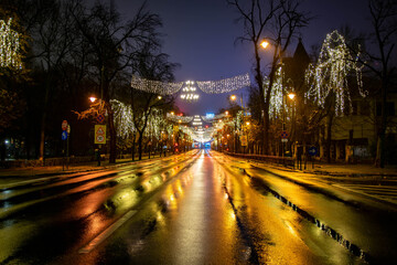 Fototapeta na wymiar Christmas lights at night on public street