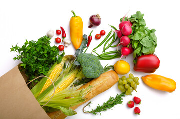 Fresh vegetables and fruits in paper bag, top view
