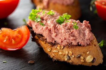 Toast with pork pate, tomato and herbs