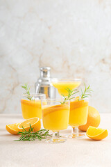Summer refreshing orange cocktail with rosemary and fresh fruits