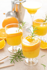 Summer refreshing orange cocktail with rosemary and fresh fruits