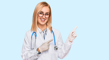 Beautiful caucasian woman wearing doctor uniform and stethoscope smiling and looking at the camera pointing with two hands and fingers to the side.