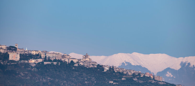 Stunning panoramic view of Veroli town with snow capped mountains in the distance. Veroli is a town and comune in province of Frosinone, Lazio, central Italy.