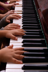 Young pianists playing music on old piano