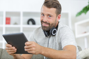 a happy man using tablet