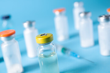 Bottle of coronavirus vaccine with syringe for injection
