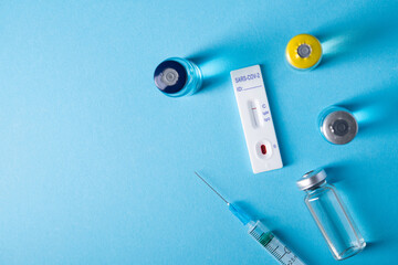 Coronavirus vaccine with syringe for injection and rapid test to detect virus infection