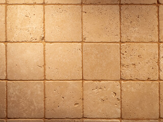 Fototapeta premium Old square stone tiles with brown holes. Retro texture background.