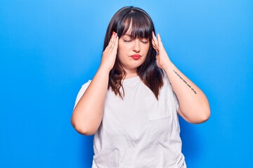 Young plus size woman wearing casual clothes suffering from headache desperate and stressed because pain and migraine. hands on head.