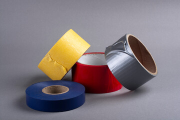 Several rolls of duct tape on a gray background.
