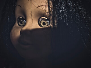 Creepy scary old vintage doll face with black hair smiling