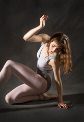 Fototapeta na wymiar Young woman dancing on the floor in the studio.