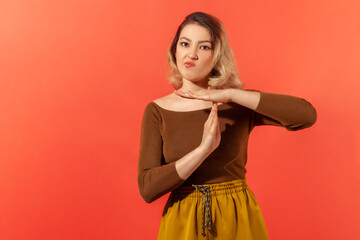 I need time out!Portrait of young upset woman want to take a rest or have a break and showing...