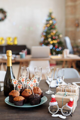 Group of tasty homemade muffins with small xmas cards on plate and other stuff