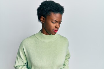 Young african american girl wearing casual clothes with hand on stomach because indigestion,...