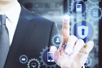 Close up of businessman hand using digital business interface.
