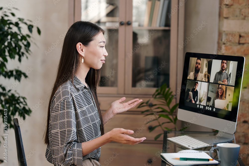 Poster confident and smiling young manager talking to colleagues on computer screen
