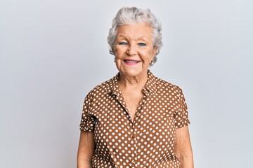 Senior grey-haired woman wearing casual clothes with a happy and cool smile on face. lucky person.