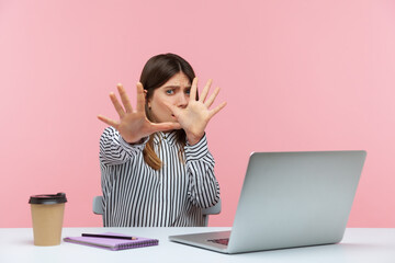 No, I'm scared! Frightened woman with shocked expression raising hands in stop gesture, defending herself, freaked out of troubles working on laptop. Indoor studio shot isolated on pink background - obrazy, fototapety, plakaty