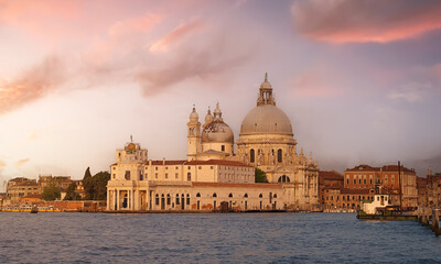 
panoramic view of the basilica of Santa Maria della Salute and the Gothic and medieval architecture of Venice from the Grand Canal