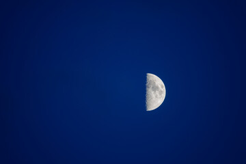 Half moon in the blue sky.