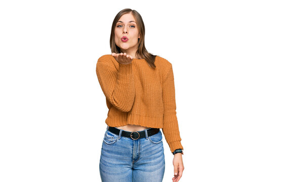 Beautiful caucasian woman wearing casual clothes looking at the camera blowing a kiss with hand on air being lovely and sexy. love expression.