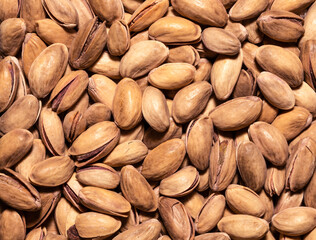 Roasted pistachios texture, close-up. Nuts background.