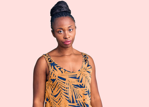 Young african american woman wearing casual clothes looking sleepy and tired, exhausted for fatigue and hangover, lazy eyes in the morning.