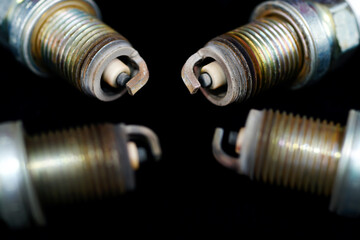 Spark plugs on black background, Old used spark plugs.