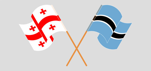 Crossed and waving flags of Georgia and Botswana