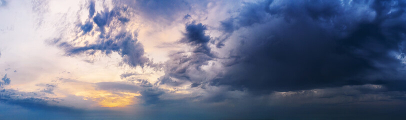 Naklejka na ściany i meble Dramatic sunset sky with dark clouds.