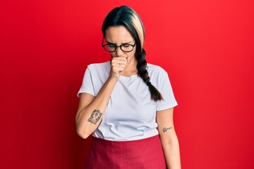 Young hispanic woman wearing professional waitress apron feeling unwell and coughing as symptom for cold or bronchitis. health care concept.