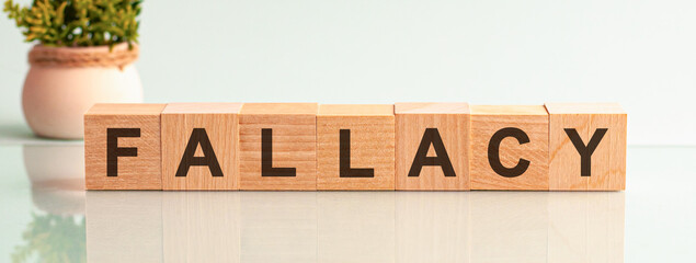 Fallacy motivation text on wooden blocks business concept white background. Front view concepts,...