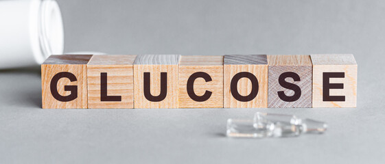 glucose is a word written in black letters on wooden cubes
