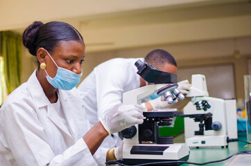 african health care researchers working in life science laboratory. young female research scientist...