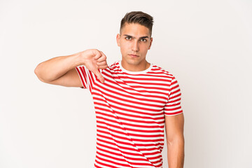 Young caucasian handsome man isolated showing a dislike gesture, thumbs down. Disagreement concept.