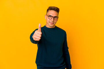 Young handsome caucasian man isolated smiling and raising thumb up