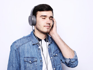 Handsome Man lictening to music over white background