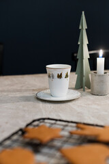 Christmas cookies, candle and coffee background concept with space for text and type, concrete table with coffee and christmas gingerbread cookies