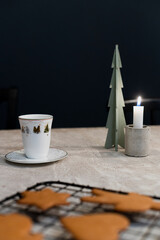 Christmas cookies, candle and coffee background concept with space for text and type, concrete table with coffee and christmas gingerbread cookies