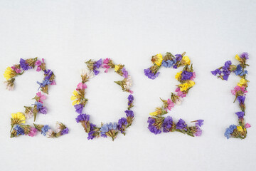 2021 written with small, colorful flowers