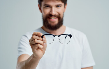 a man with glasses in his hand vision problems eye pain myopia hyperopia lenses